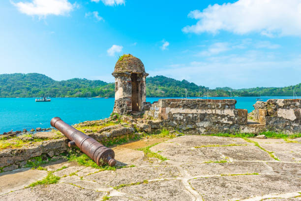 Portobelo Fortress, Caribbean Sea, Panama Ancient Spanish fortress with shooting tower and cannon by the Caribbean Sea to protect the custom from pirate attacks, Portobelo, Panama. Also a known place for it is where Christopher Columbus saw the Central America for the first time during his fourth voyage. artillery photos stock pictures, royalty-free photos & images