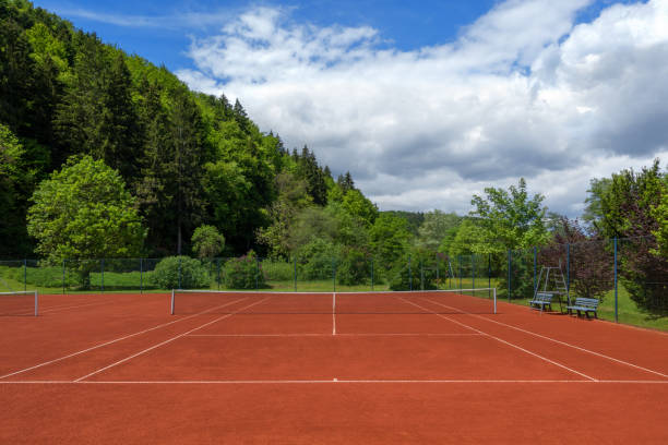 Clean pulled tennis court after the spring overhaul Clean pulled tennis court with red sand after the spring overhaul clay court stock pictures, royalty-free photos & images
