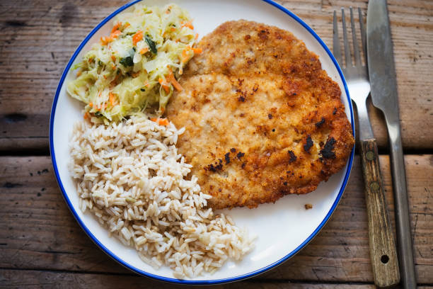 istock Polish breaded pork cutlet with rice and vegetable salad 1152676527