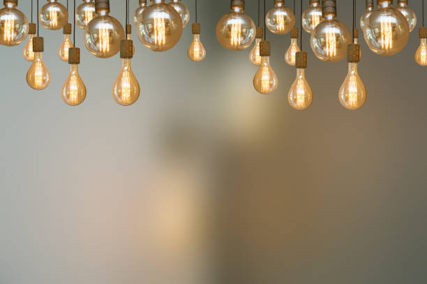 istock burning retro light bulb on blurred background colorful vintage design 1152679137