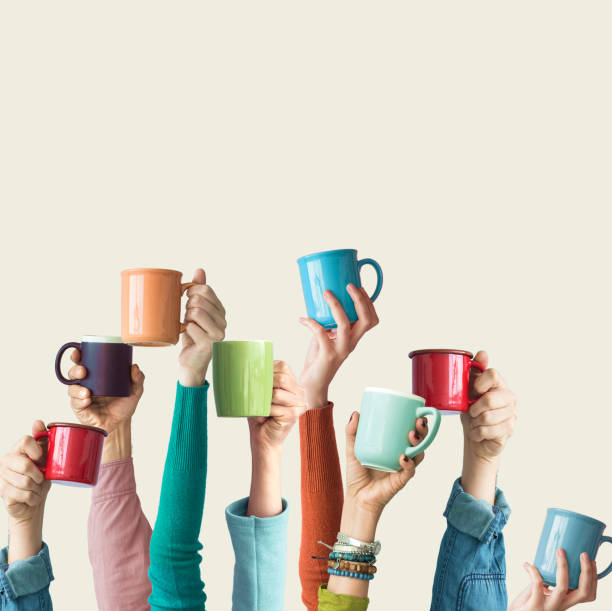 istock Many different arms raised up holding coffee cup 1152679223