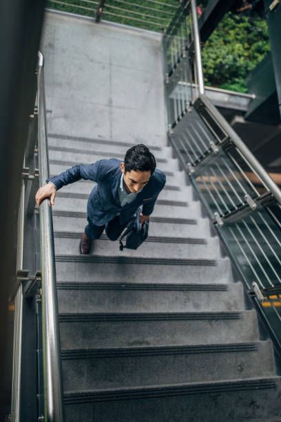 istock Businessman walking up stairway 1152679520