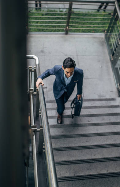 istock Businessman walking up stairway 1152679554