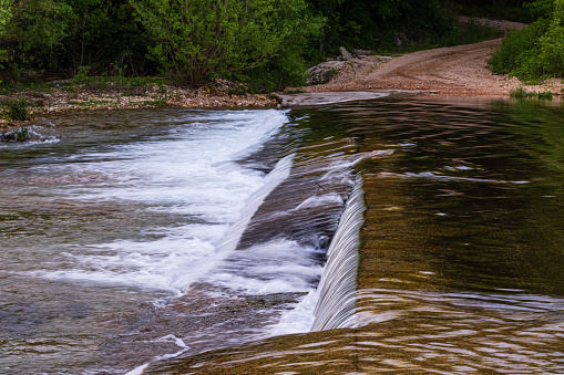 The water of Spring Creek flowing over the concrete slab bridge located in Teresita, Oklahoma 2019