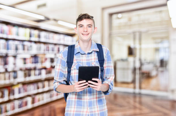 istock 13 year old teenage boy - using tabet 1152682585