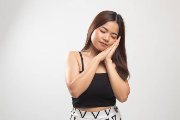 istock Beautiful young Asian woman with sleeping gesture. 1152682831