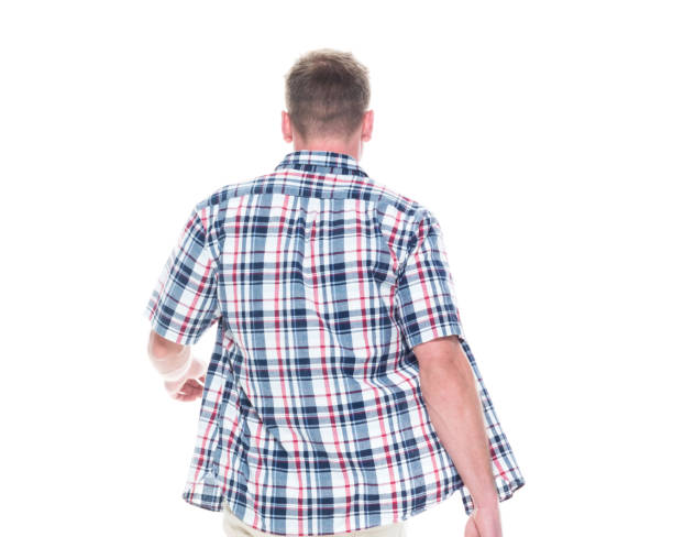 istock Handsome man in shirt and shorts is walking away 1152684892