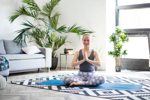 istock Woman practicing yoga at home 1152685096