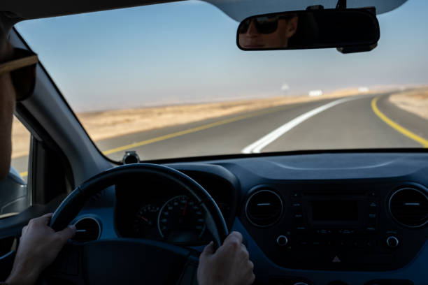 istock young man driving a rented car in the desert 1152685174