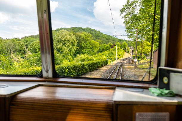 istock A view from the window of a moving train, visible tracks, trees and blue sky with white clouds. 1152688118