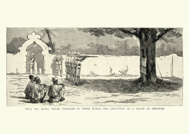 Execution by firing squad of a armed robber, Burma, 1886 Vintage engraving of Royal Welsh Fusiliers in Upper Burma, Execution by firing squad of a Dacoit at Shway-Bo, 1886. A dacoit in India or Burma is a member of a band of armed robbers. firing squad stock illustrations
