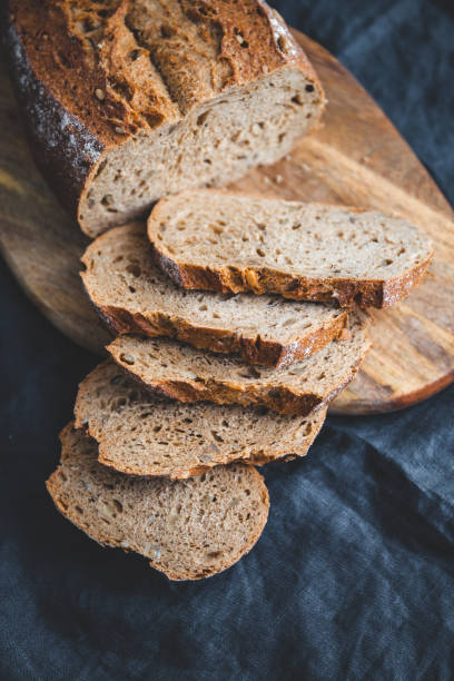 istock Rye bread with sunflower seeds on a wooden cutting board. 1152689345