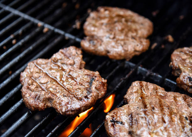 istock Grilling burgers on a barbecue 1152691166