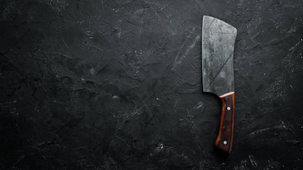 istock Kitchen old knife on a black stone table. Top view. Free space for your text. 1152691350