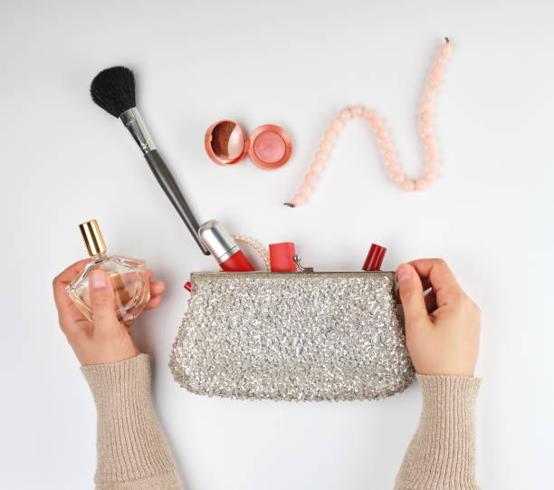 istock two female hands and a silver cosmetic bag with cosmetics 1152691493