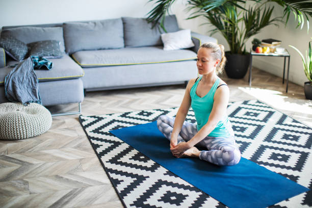 istock Woman practicing yoga at home 1152691592
