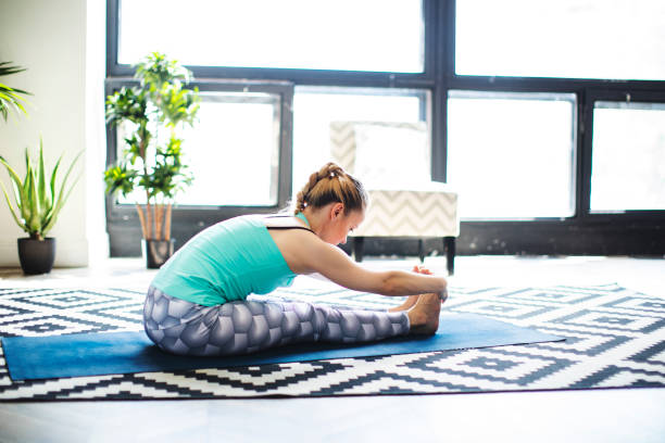 istock Woman practicing yoga at home 1152691595