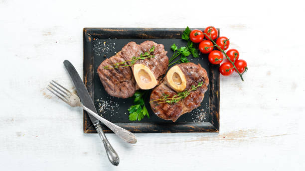 istock Beef shank roasted on a grill on a white background. Top view. Free space for your text. 1152691631