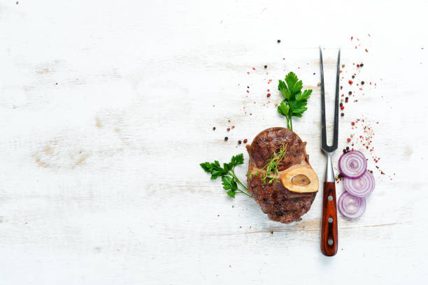 istock Beef shank roasted on a grill on a white background. Top view. Free space for your text. 1152691642