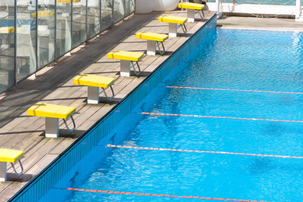 les blocs de départ, la plate-forme de saut dans la rangée par la piscine. - vacant block photos et images de collection