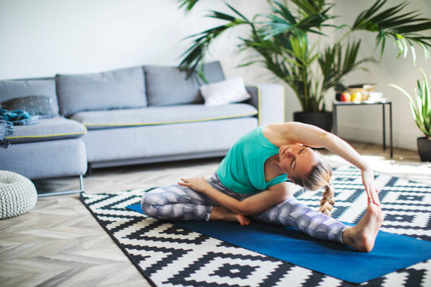 istock Woman practicing yoga at home 1152692883