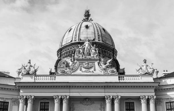 A black and white picture of the top section of the main facade of The Hofburg (Vienna).
