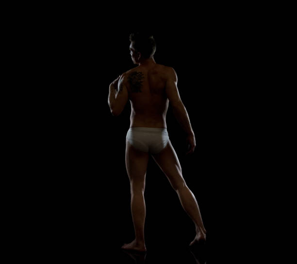 istock Sexy man wearing underwear on black background 1152694265