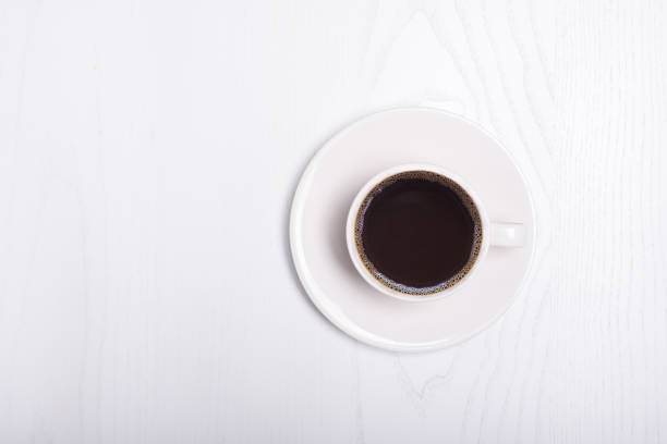 istock Coffee cup top view on wooden white table background 1152694529