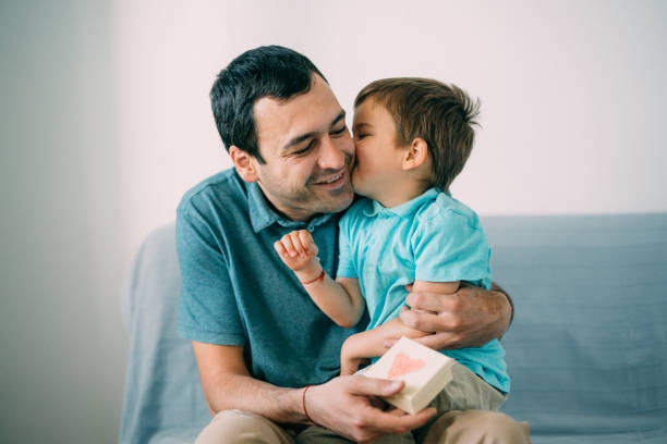 Boy surprising his father with a gift for Father's Day