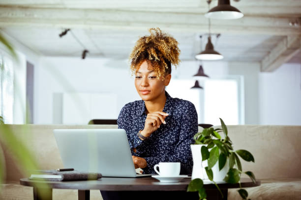 istock Skilled female worker looking at laptop in office 1152695956