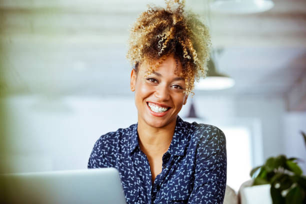 istock Cheerful female entrepreneur working in office 1152696045