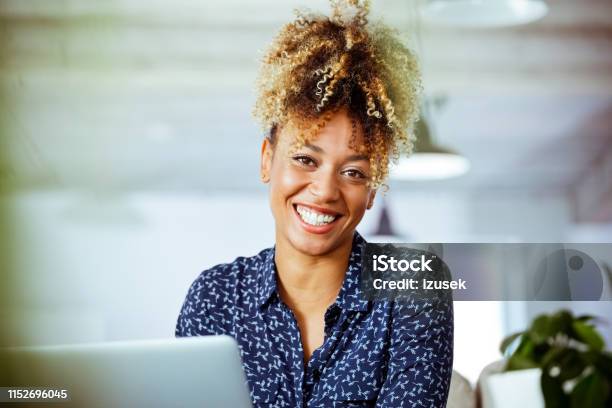 Cheerful Female Entrepreneur Working In Office Stock Photo - Download Image Now - Financial Advisor, Headshot, Expertise