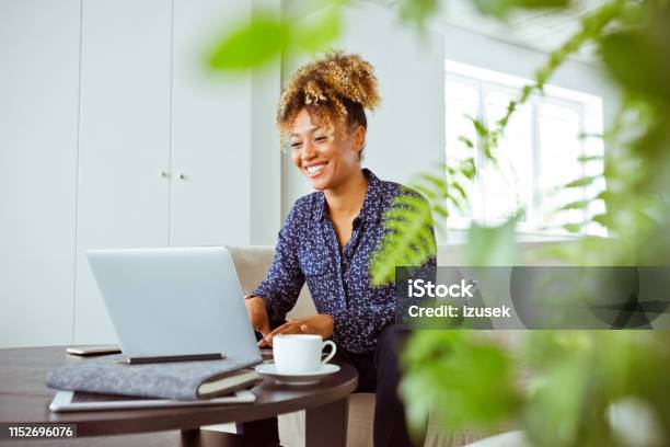 Smiling Female Financial Advisor Working In Office Stock Photo - Download Image Now - Financial Advisor, One Woman Only, Sitting