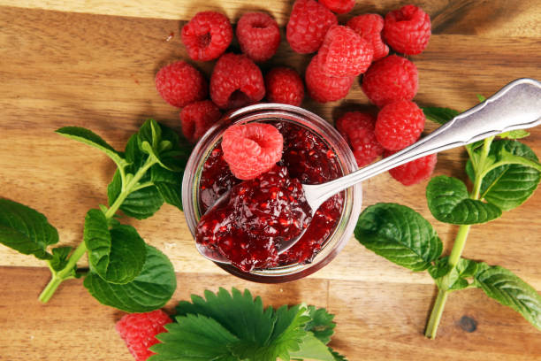 istock raspberry jam with fresh raspberries and mint. marmalade on spoon and jar 1152697105