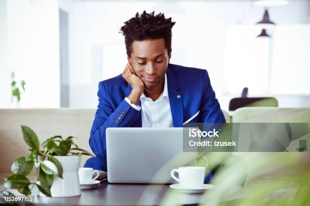 Bored Male Entrepreneur Sitting In Office Stock Photo - Download Image Now - Blue, Business, Computer