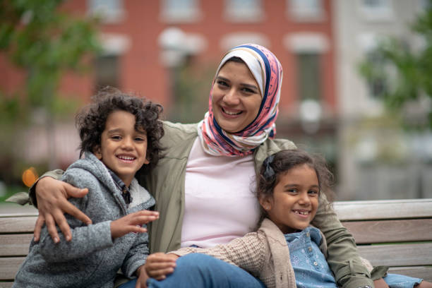 istock Muslim family sitting on a bench 1152699686