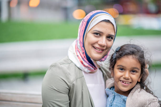 istock Muslim family sitting on a bench 1152699694