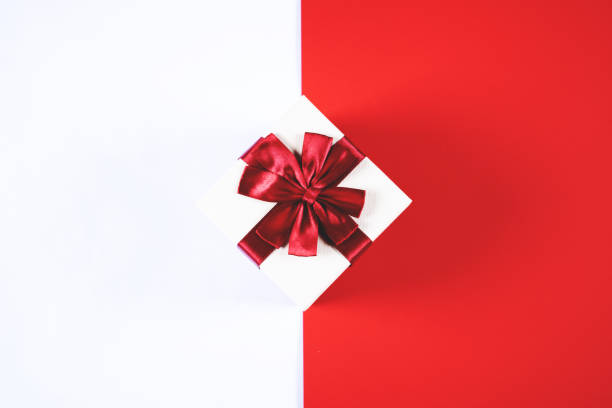 istock Beautiful present box on red and white background. 1152701994