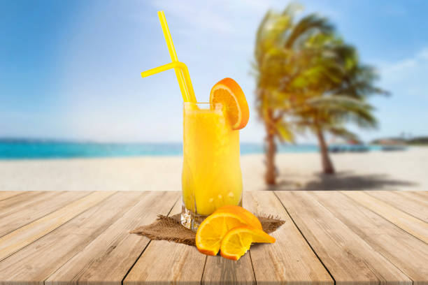 istock Tropical orange cocktail with sea and palm view 1152703507