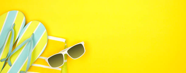 istock Summer vacation beach accessories banner on a yellow background with copy space 1152703957
