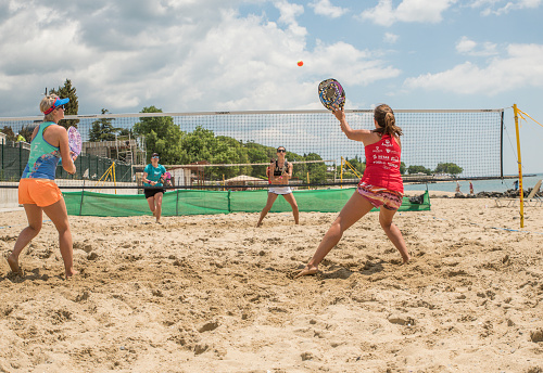 Sveti Vlas, Bulgaria - May 24, 2019: Young women playing beach tennis on  beach