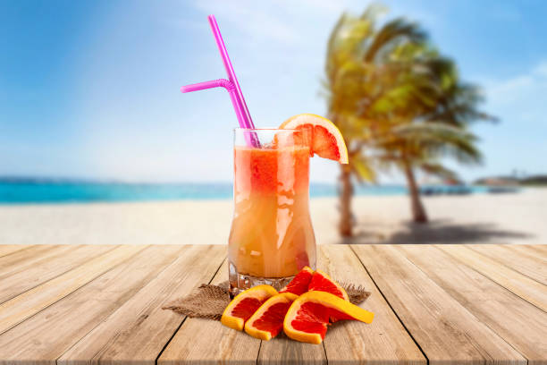 istock Tropical grapefruit cocktail with sea and palm view 1152704744