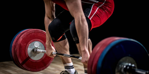 istock Weightlifter lifting barbell 1152704907