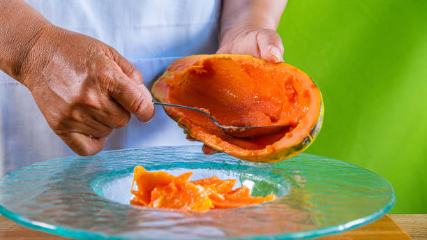 istock Closeup of hands holding a papaya 1152705100