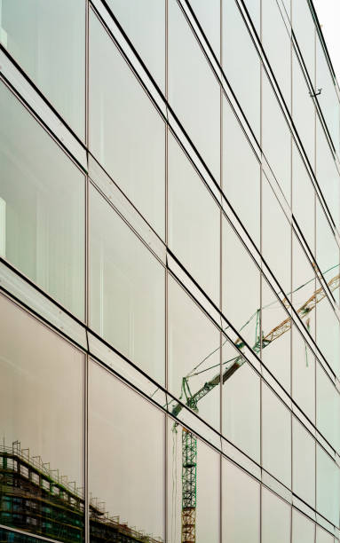 istock Reflection of Lifting crane in Modern glass skyscraper house 1152706019