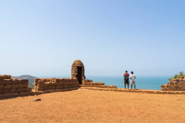 Chapora Fort in the northern Goa, India Anjuna, Goa / India - 04 03 2019, Chapora Fort in the northern Goa, India. Old ruins on top of hill. People standing looking out the ocean. chapora fort stock pictures, royalty-free photos & images
