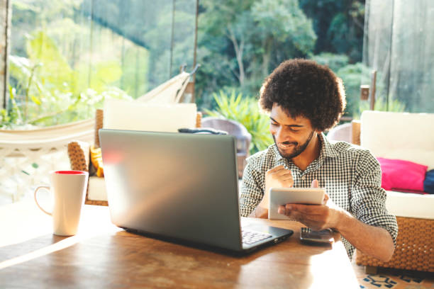 istock Young man using laptop in the living room 1152719042