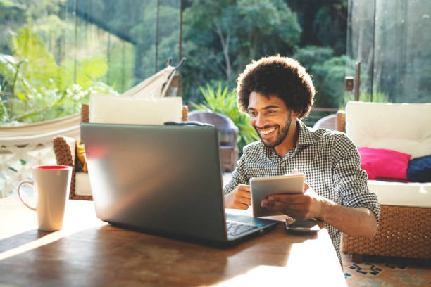 istock Young man using laptop in the living room 1152719049