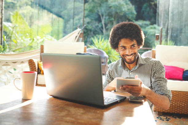 istock Young man using laptop in the living room 1152719054
