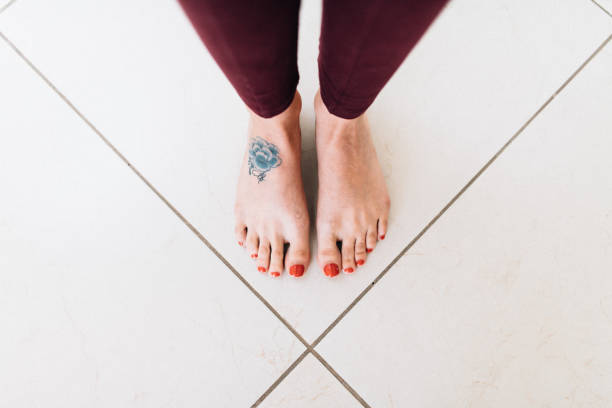 Tattooed bare feet Overhead view of tattooed female foot home pedicure stock pictures, royalty-free photos & images